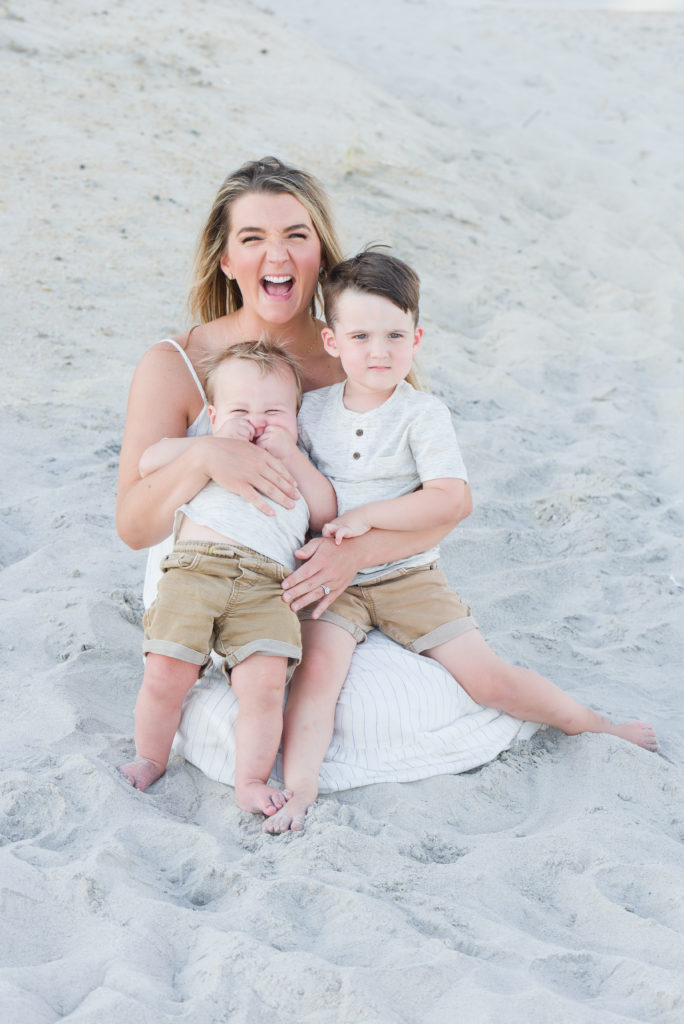 Mom holding boys on beach