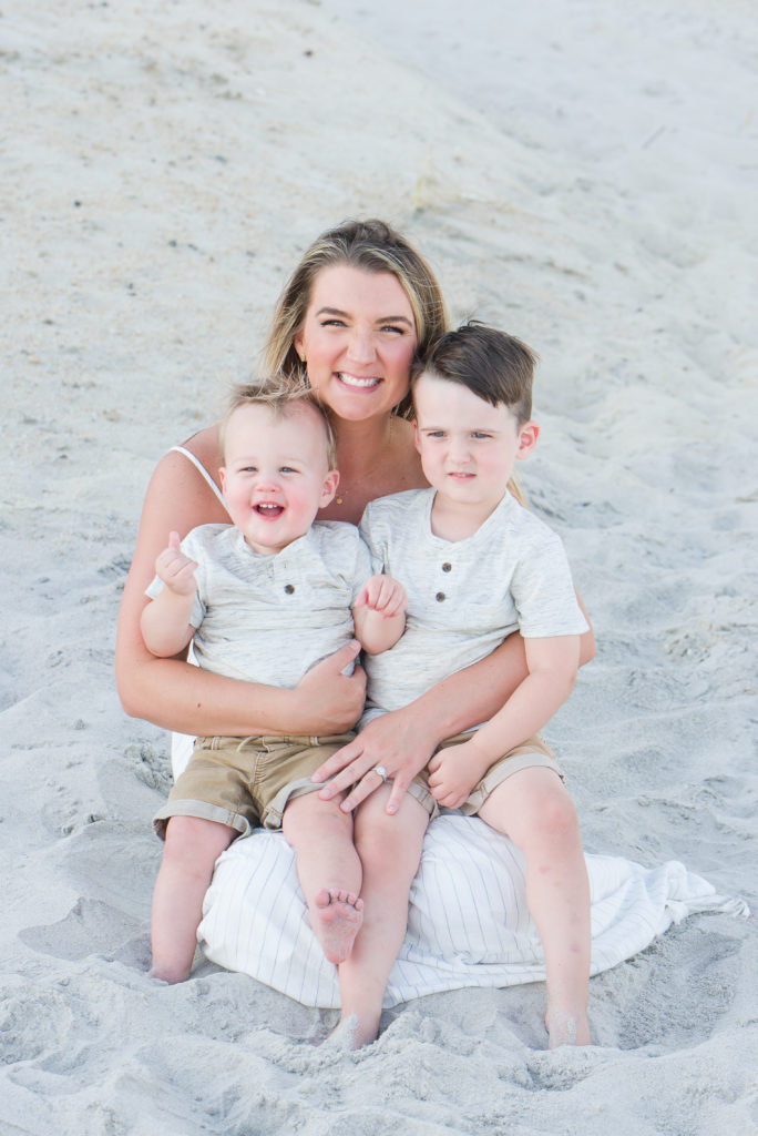 Mom holding boys on beach