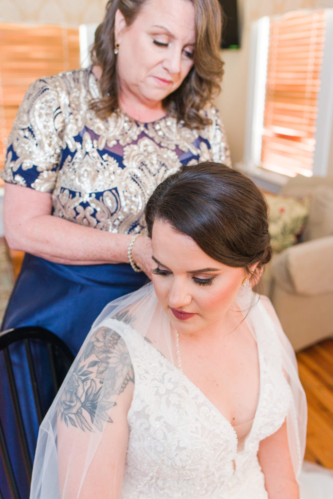 mother of the bride putting on veil