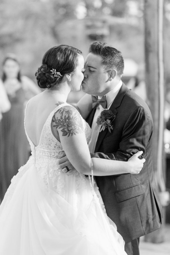 bride and groom kiss at end of first dance
