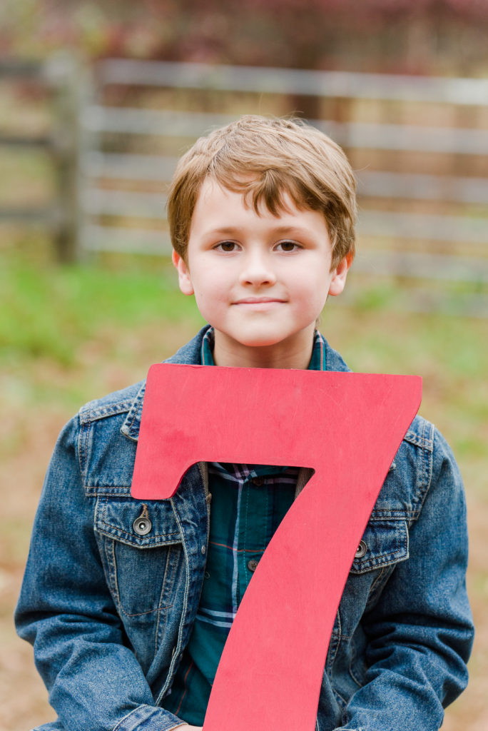child holding number 7