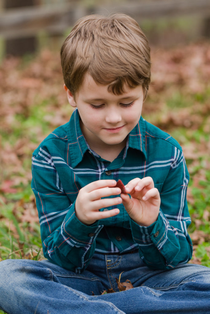 child playing with leaf