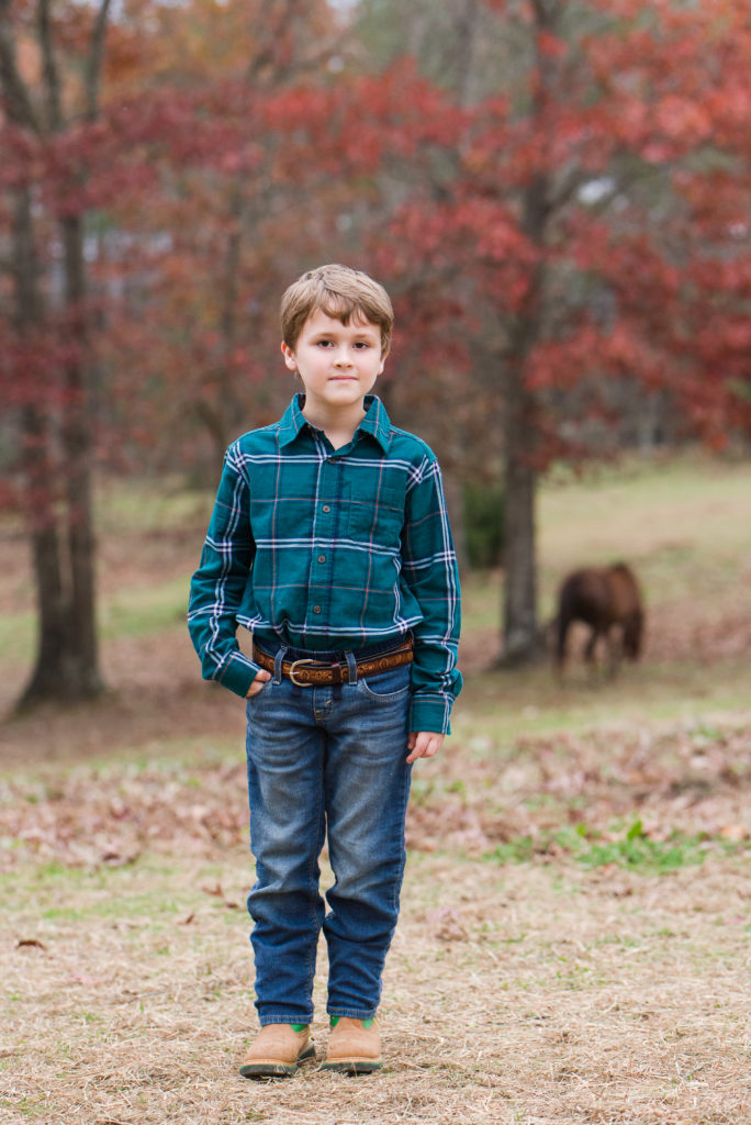 child standing in pasture