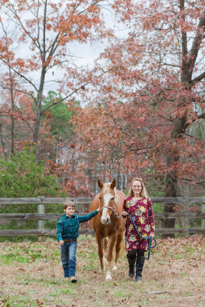 mother and son leading horse