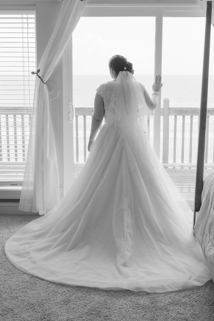 photo of bride looking out window