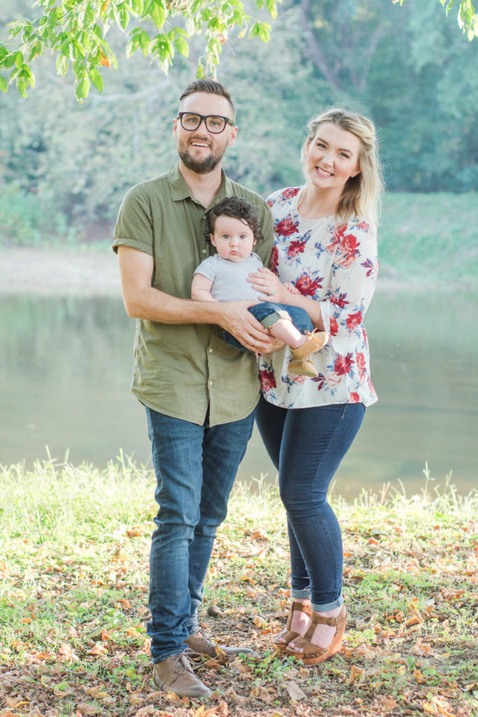 Mom and Dad with infant child in front of River