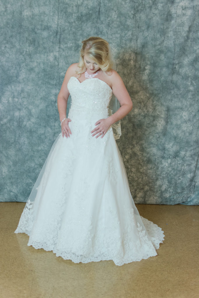 bride looking at dress
