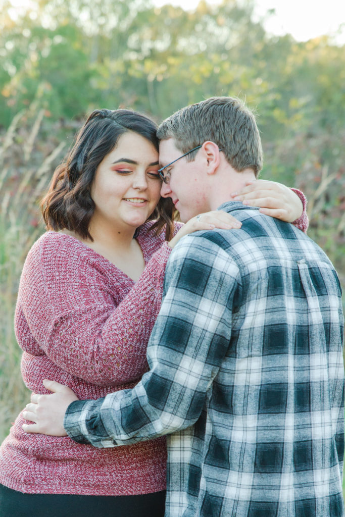 engaged couple hugging at Ivy Creek Natural Area