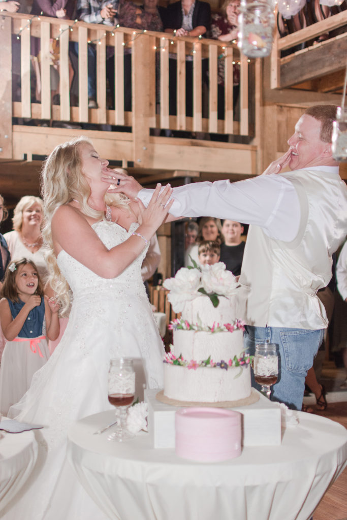 Bride and groom feeding each other cake