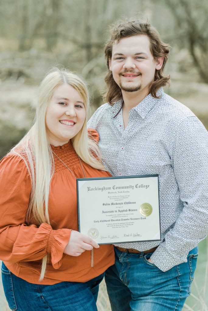 Senior portrait with fiancé holding her diploma 