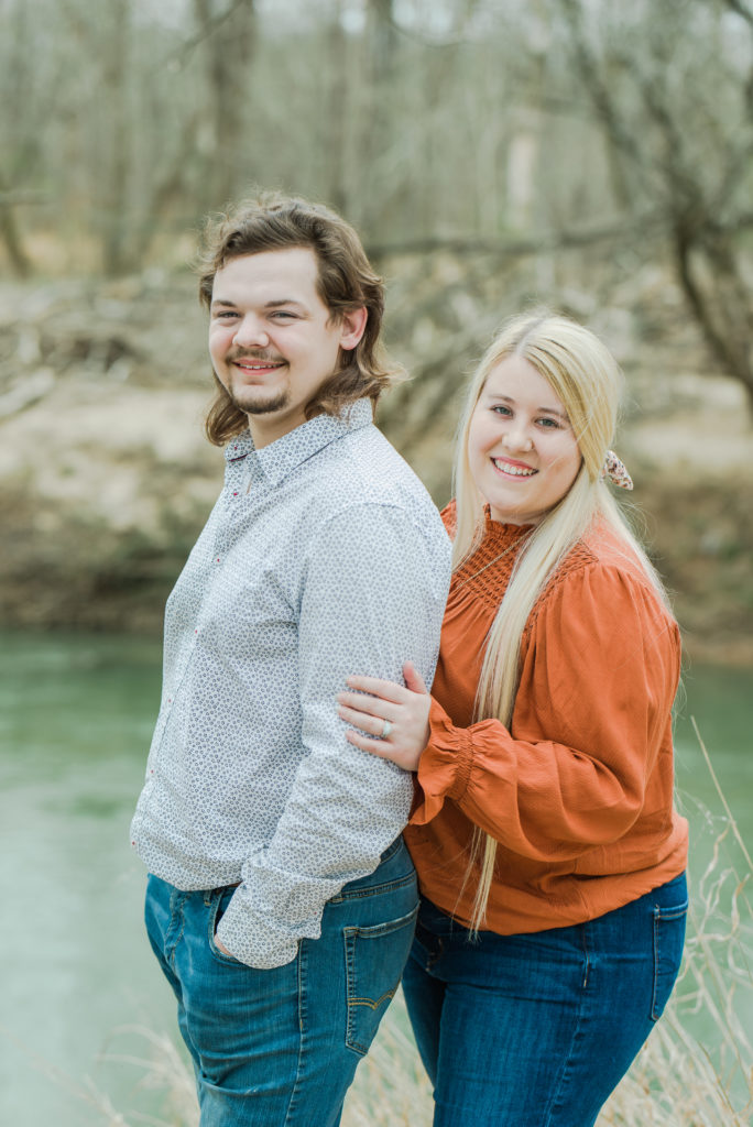 Engagement portrait of couple on river bank at Dan Daniel Park in Danville Virginia 