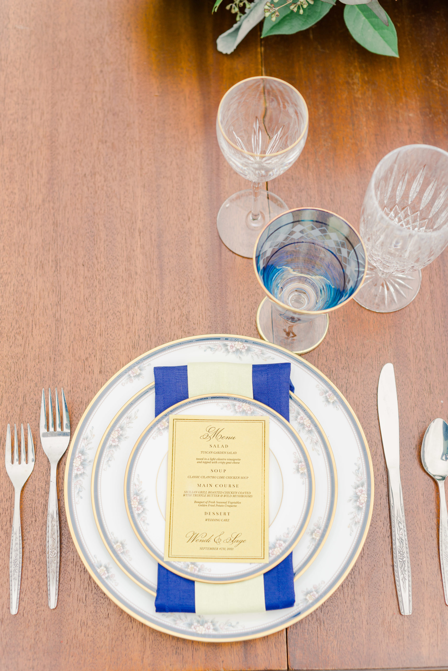 blue and yellow themed place setting for wedding reception