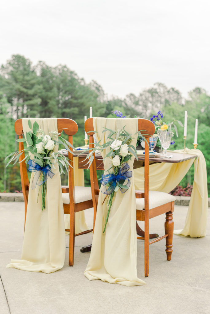 bride and groom chairs for sweetheart table at styled shoot