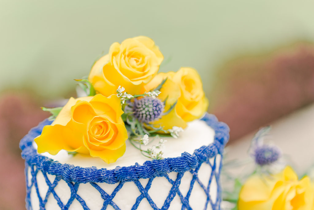 yellow roses on top of wedding cake for styled shoot