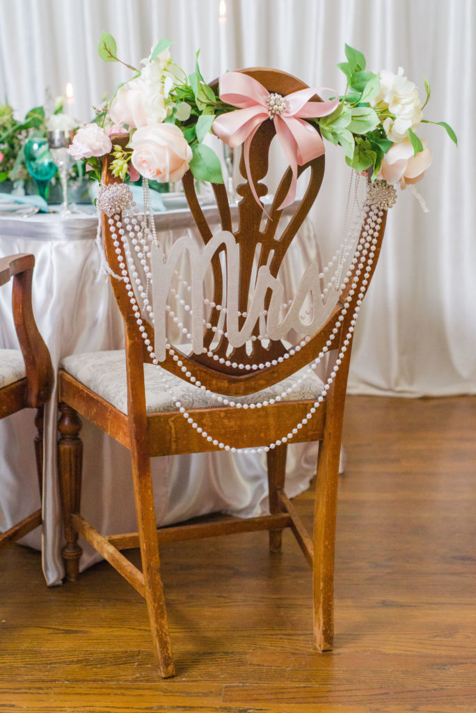 Mrs sign on bride's chair at sweetheart table