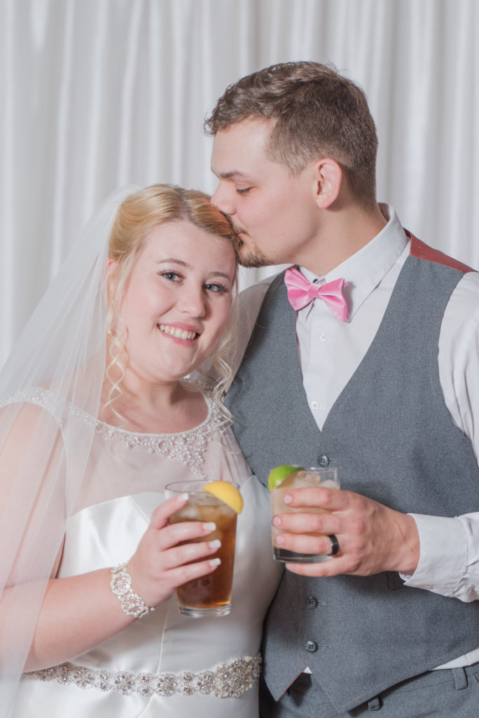 bride and groom celebrating with their signature cocktails from Bogue Sound Distillery