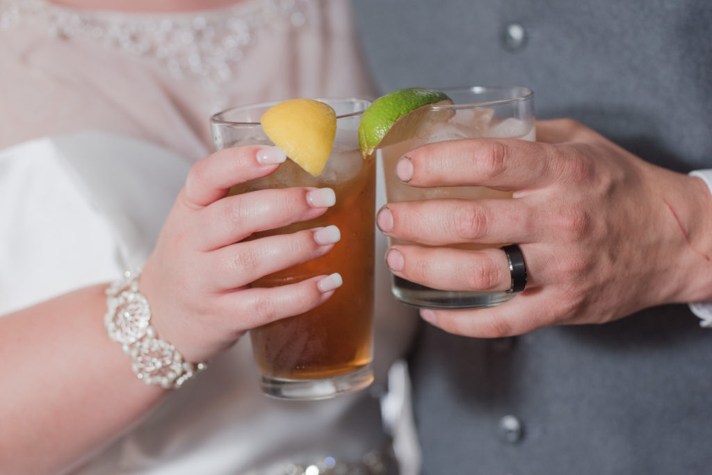 bride and grooms holding Salted Caramel Ice Tea and The Salty Dog signature cocktails