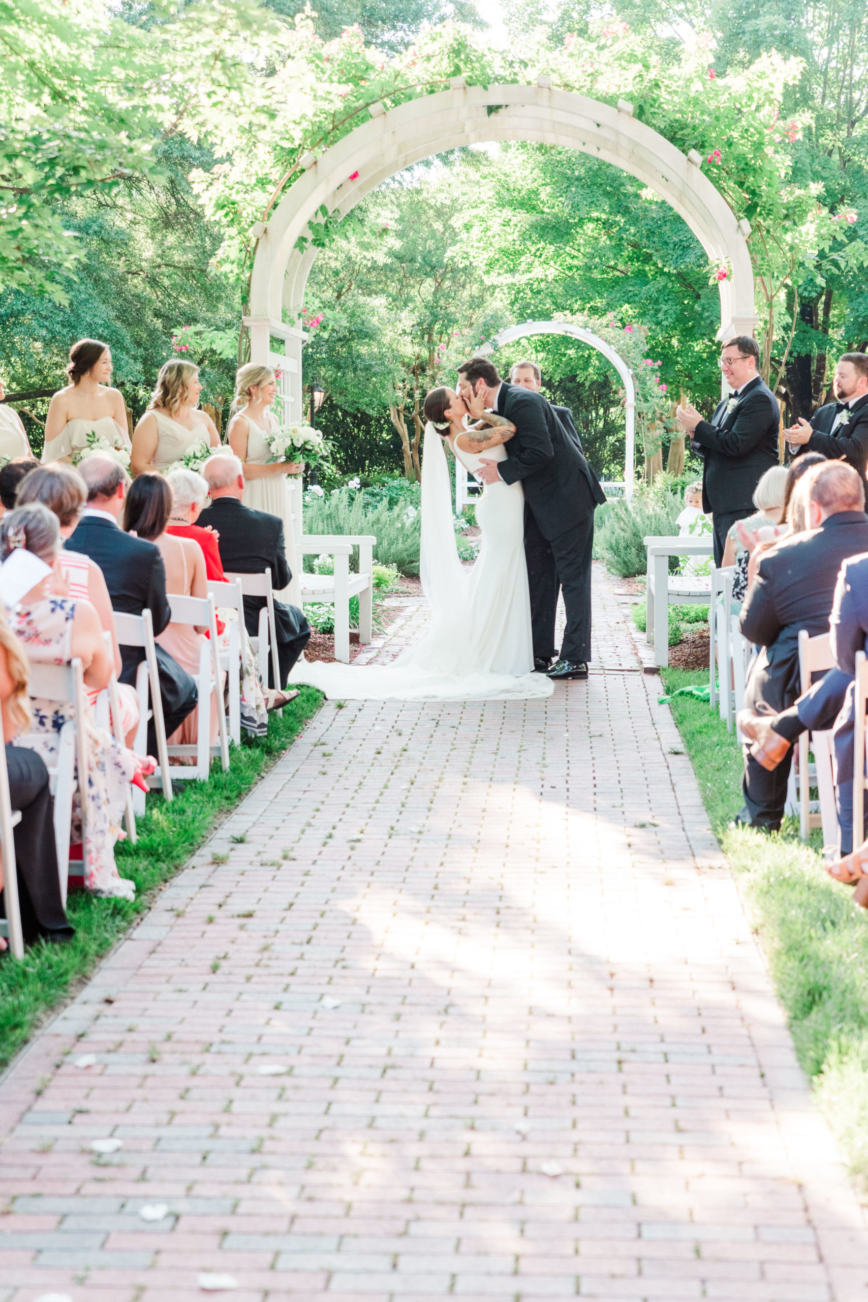 bride and groom first kiss in garden wedding in Richmond Virginia