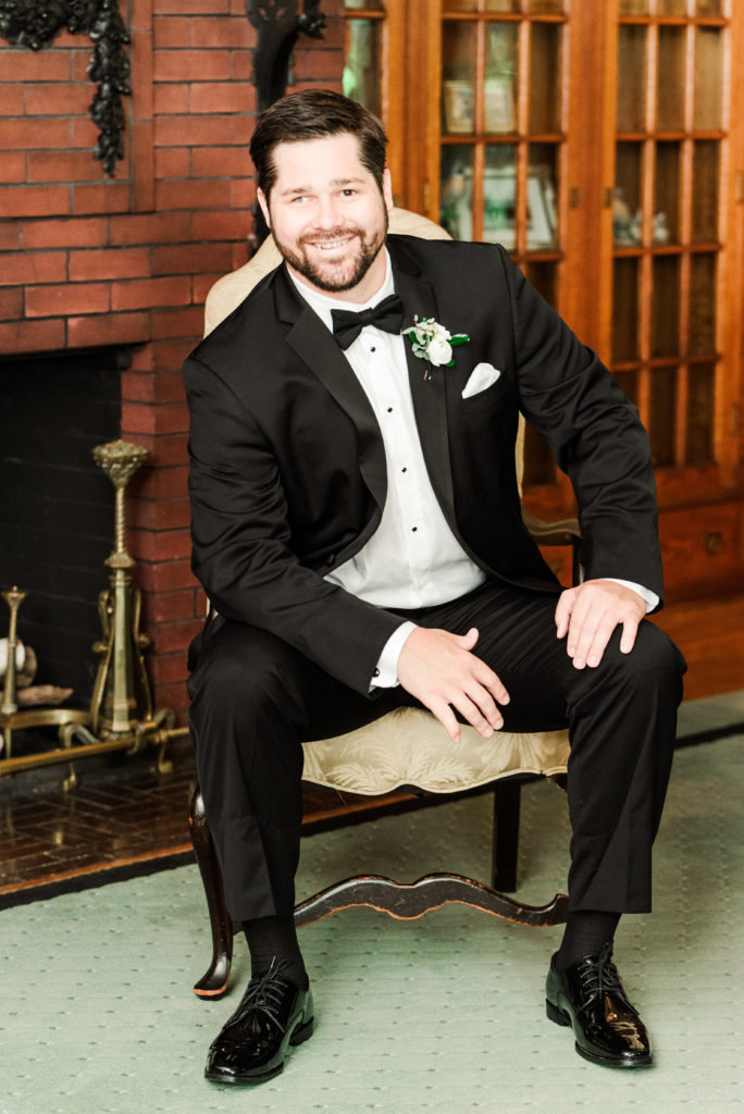 groom sitting in chair
