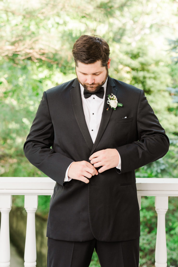 groom adjusting jacket