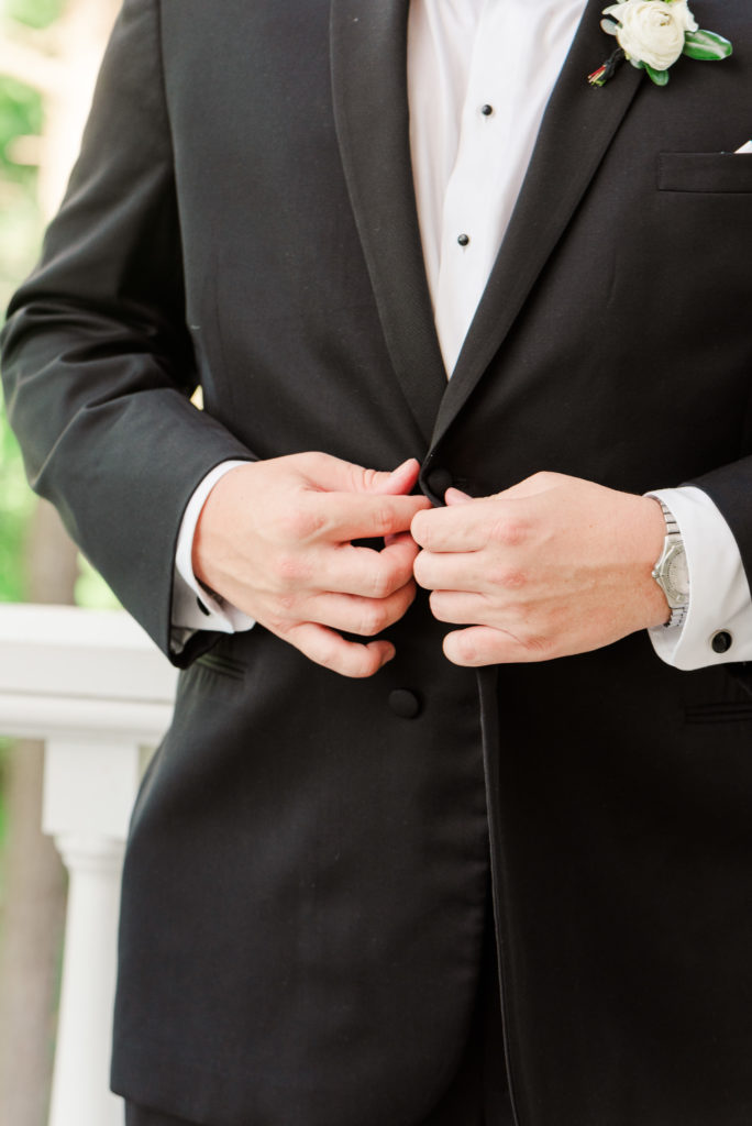 groom buttoning suit