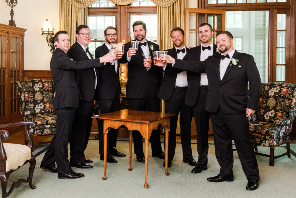 groom and groomsmen share a drink before the ceremony