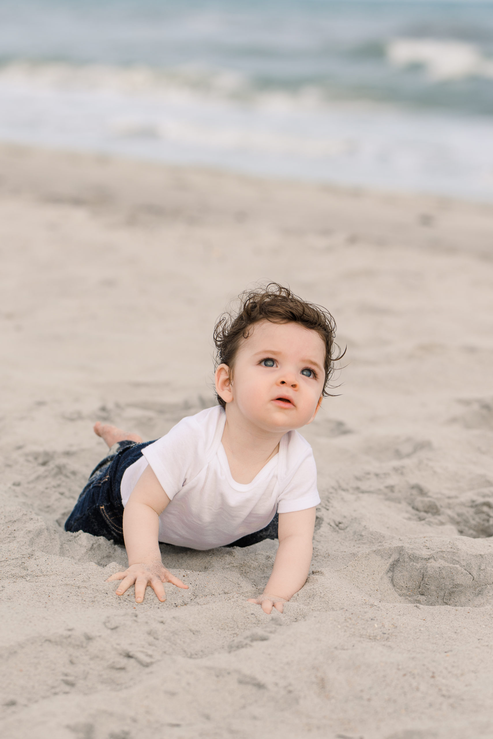 infant crawling on the beach