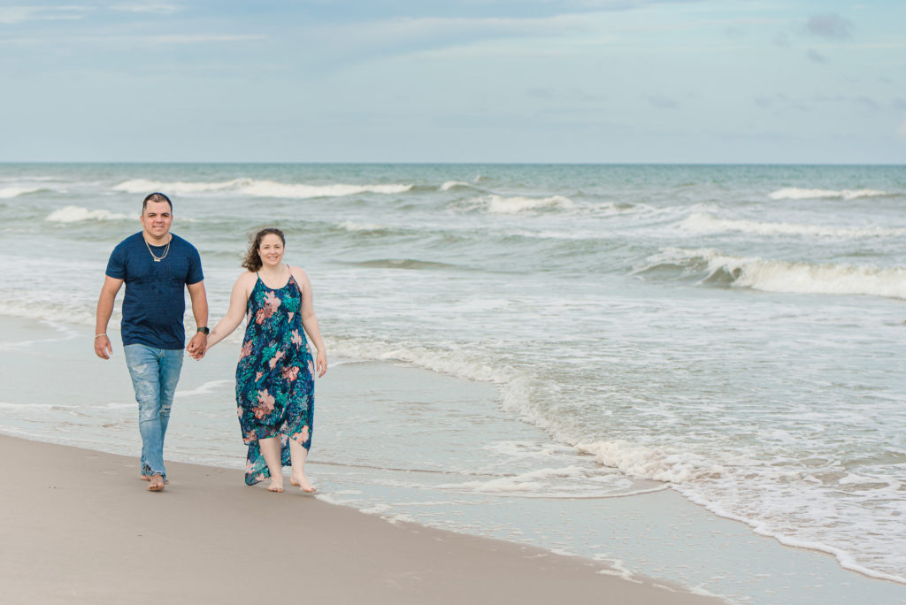 couple walking on the beach during their family session