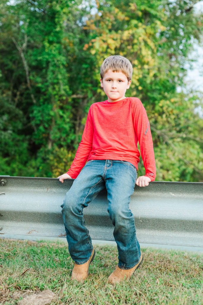 child sitting on guard rail