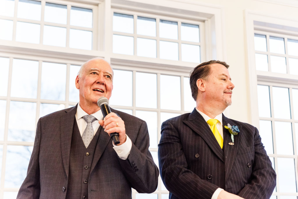 Father of the bride and father of the groom welcoming guests