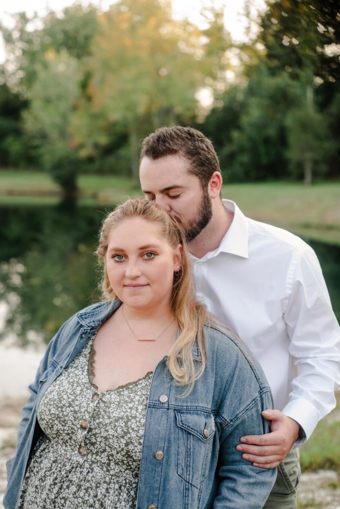 groom to be kissing during engagement session