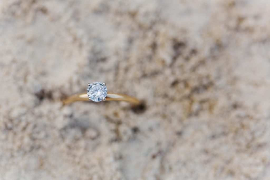 engagement ring in the sand