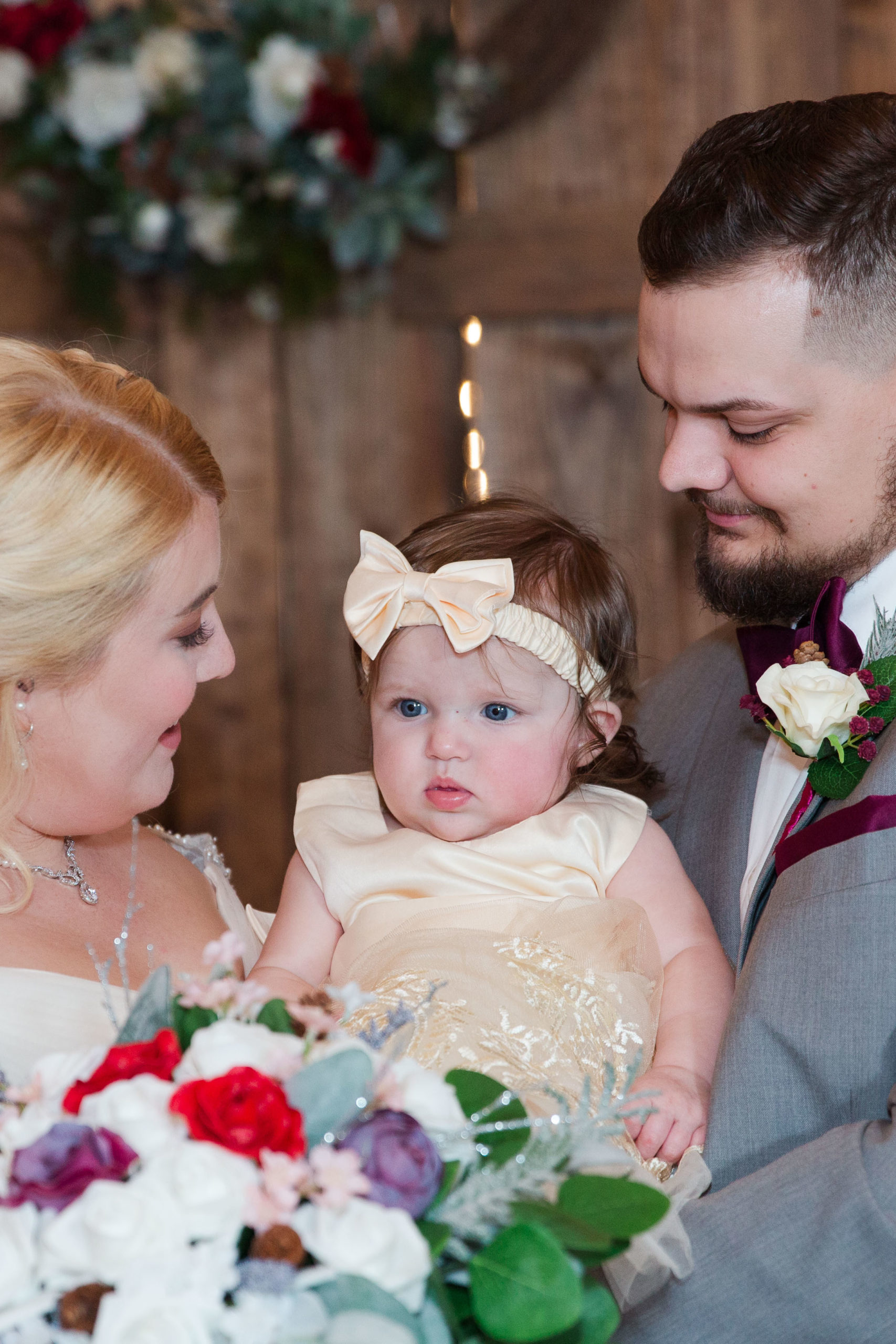 bride and groom with flower girl