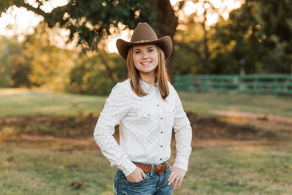 Senior portrait with cowboy hat, jeans and western shirt