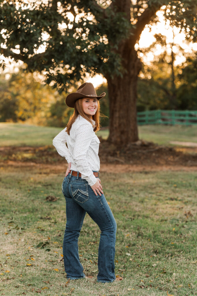 Senior portrait with jeans, cowboy hat and boots, western shirt