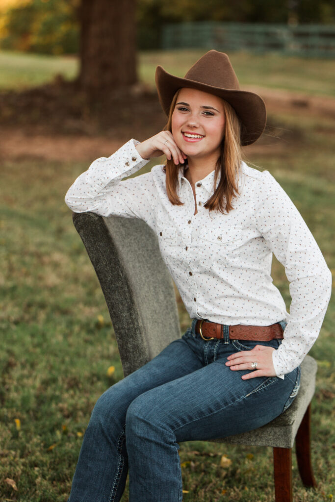 Senior portrait with cowboy hat, jeans and western shirt