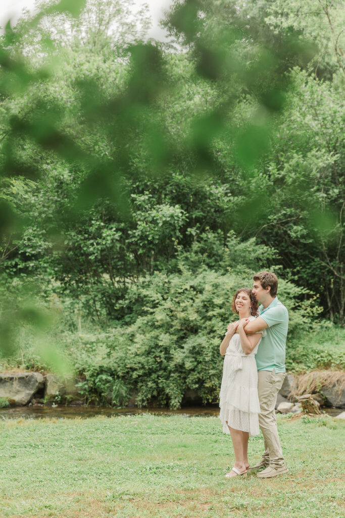 Couple holding onto each other during Engagement Session at Bold Rock Hard Cider, Nellysford, Virginia