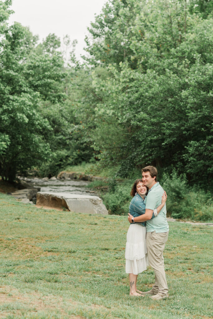 Couple embracing during Engagement Session at Bold Rock Hard Cider, Nellysford, Virginia