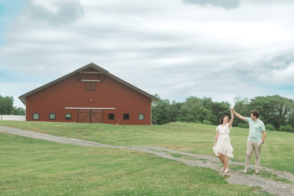 couple dancing in front of barn at Engagement Session at Bold Rock Hard Cider, Nellysford, Virginia