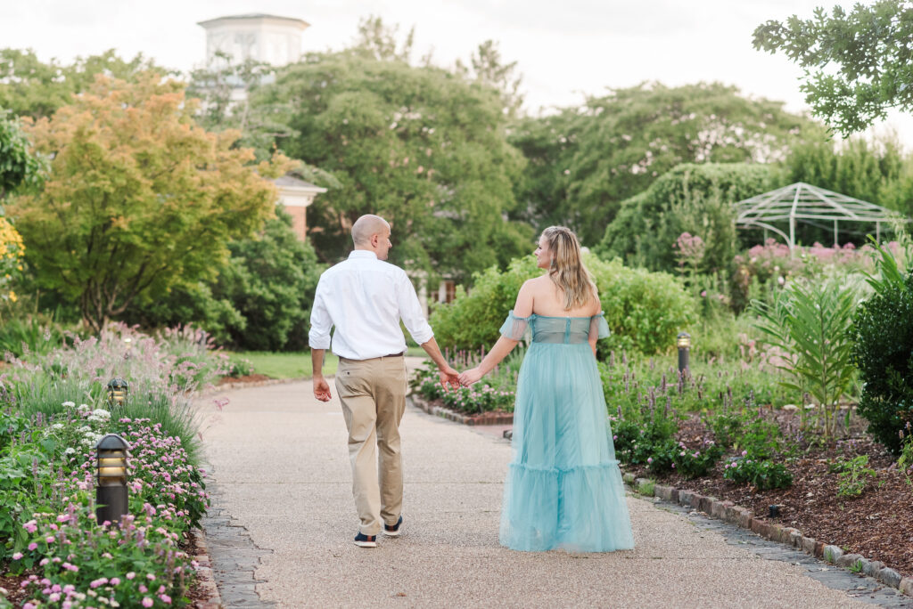 Engaged couple walking path at Lewis Ginter Botanical Garden
