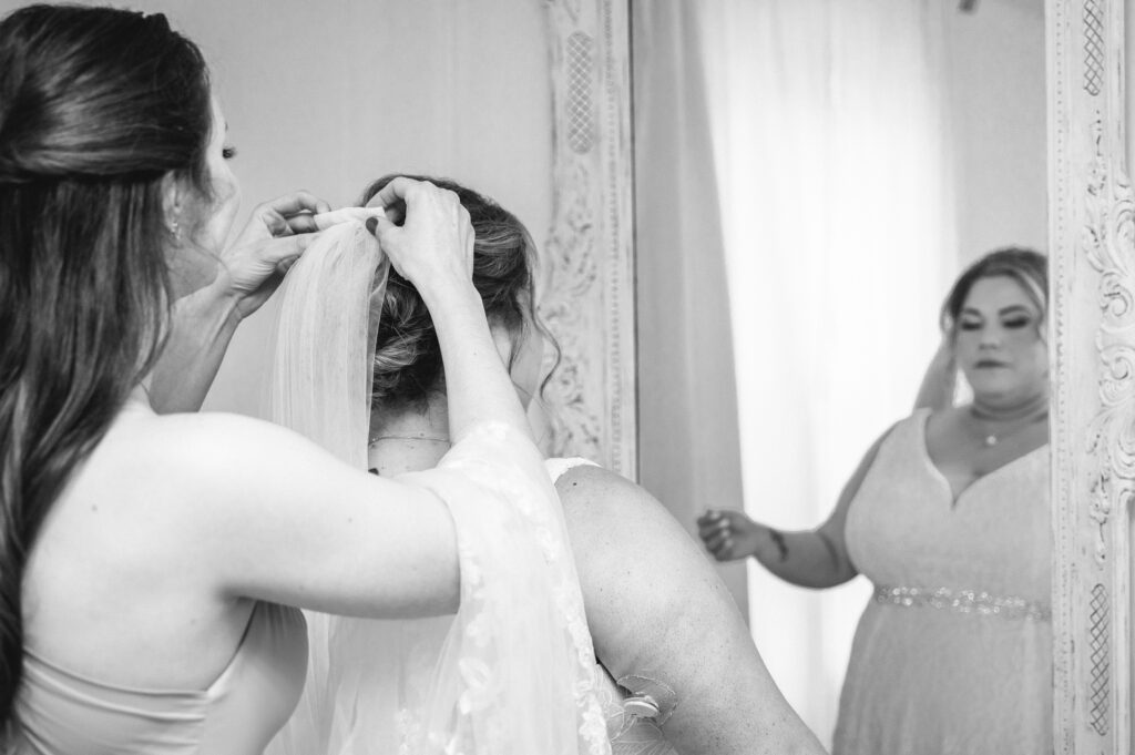 bride putting on veil