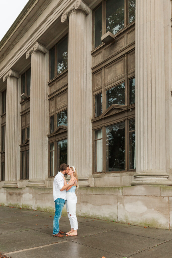 couple kissing in front of library