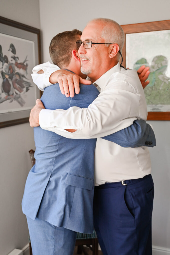 groom hugging dad