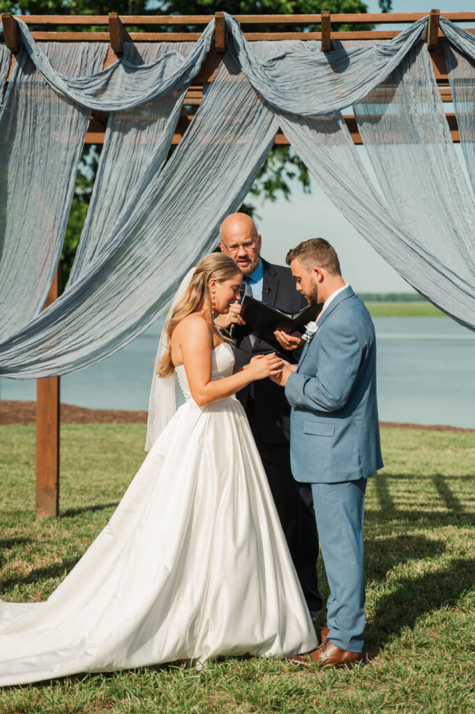 bride exchanging rings with groom