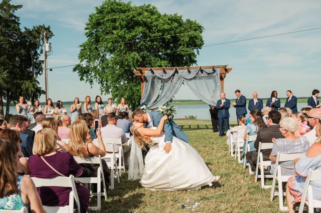 groom dipping bride during recessional