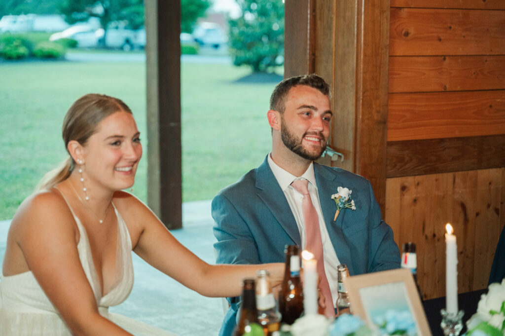 bride and groom listen to toasts