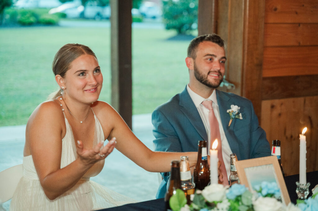 bride and groom listen to toasts