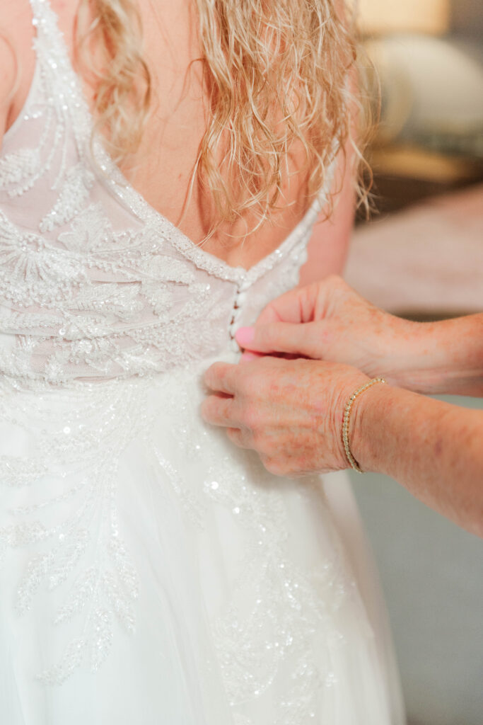 Mom zipping wedding dress 