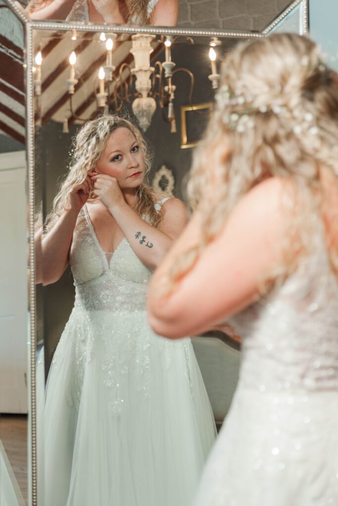 Bride putting on earrings 