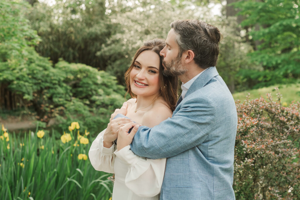 groom kissing bride's temple during engagement session